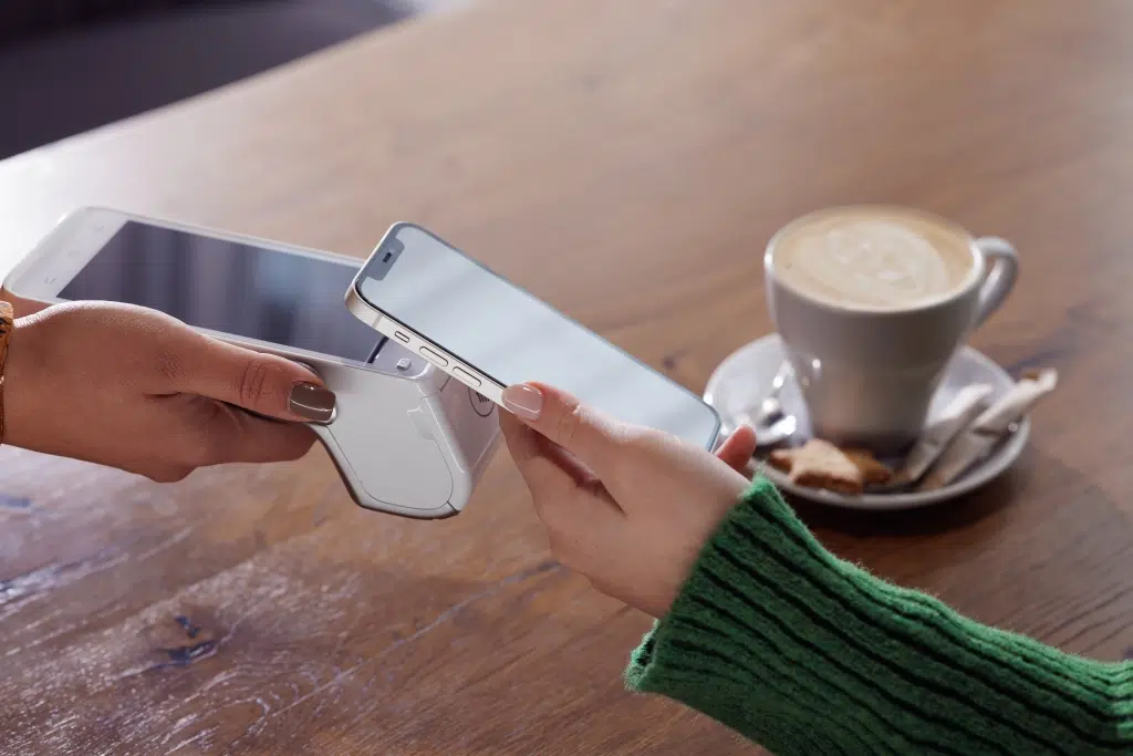 Picture of person tapping to make a payment.