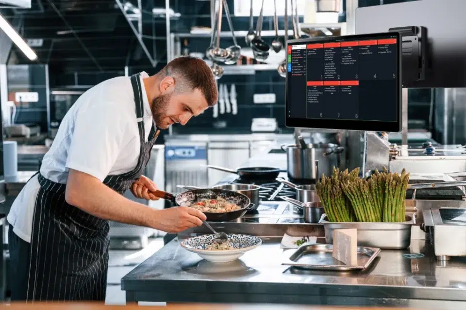 Chef working in the kitchen plating up.