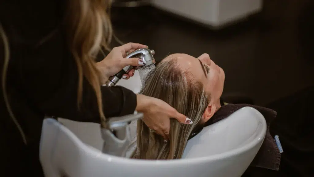 Customer having her hair washed at a salon