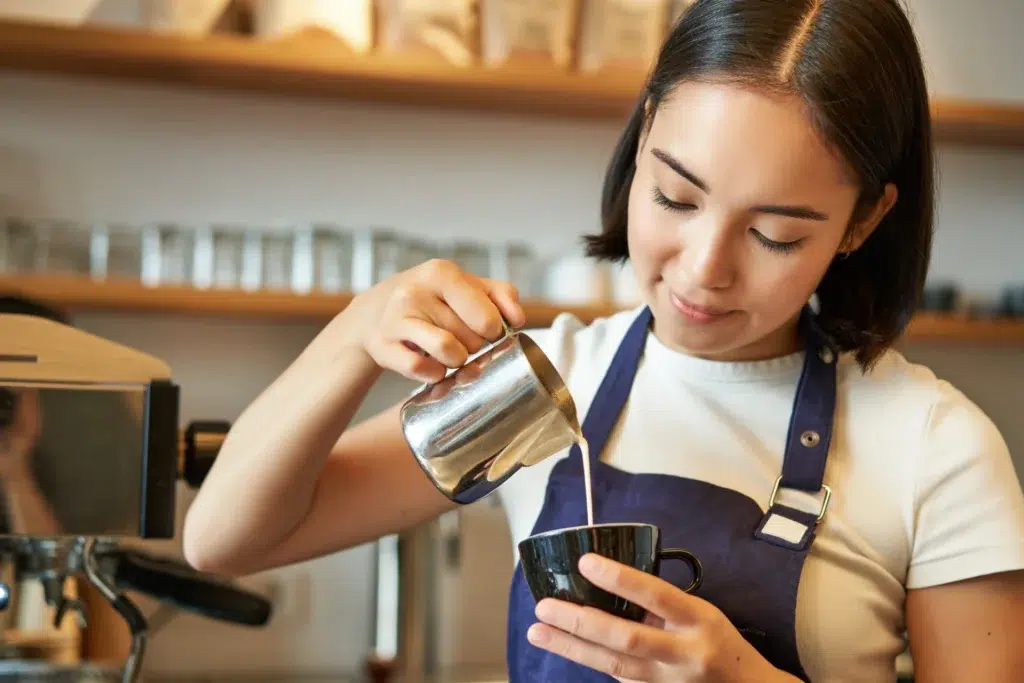 Young barista, making a coffee.